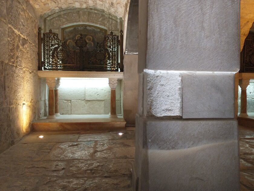 A partially restored stone pillar in the Church of the Holy Sepulchre.