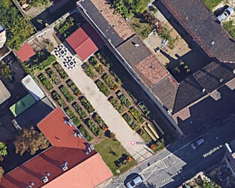 Satellite image highlighting the placement (southeast) and orientation (southeast to northwest) of our community garden parcel.
